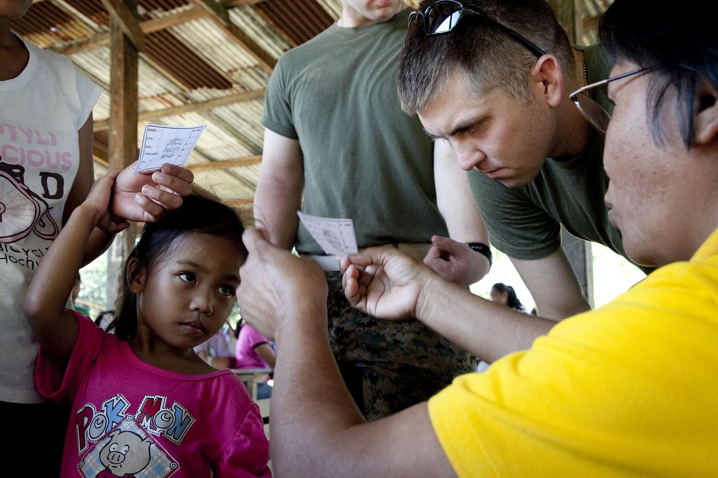 A doctor explains screening results and next steps to a patient during a clinic consultation.